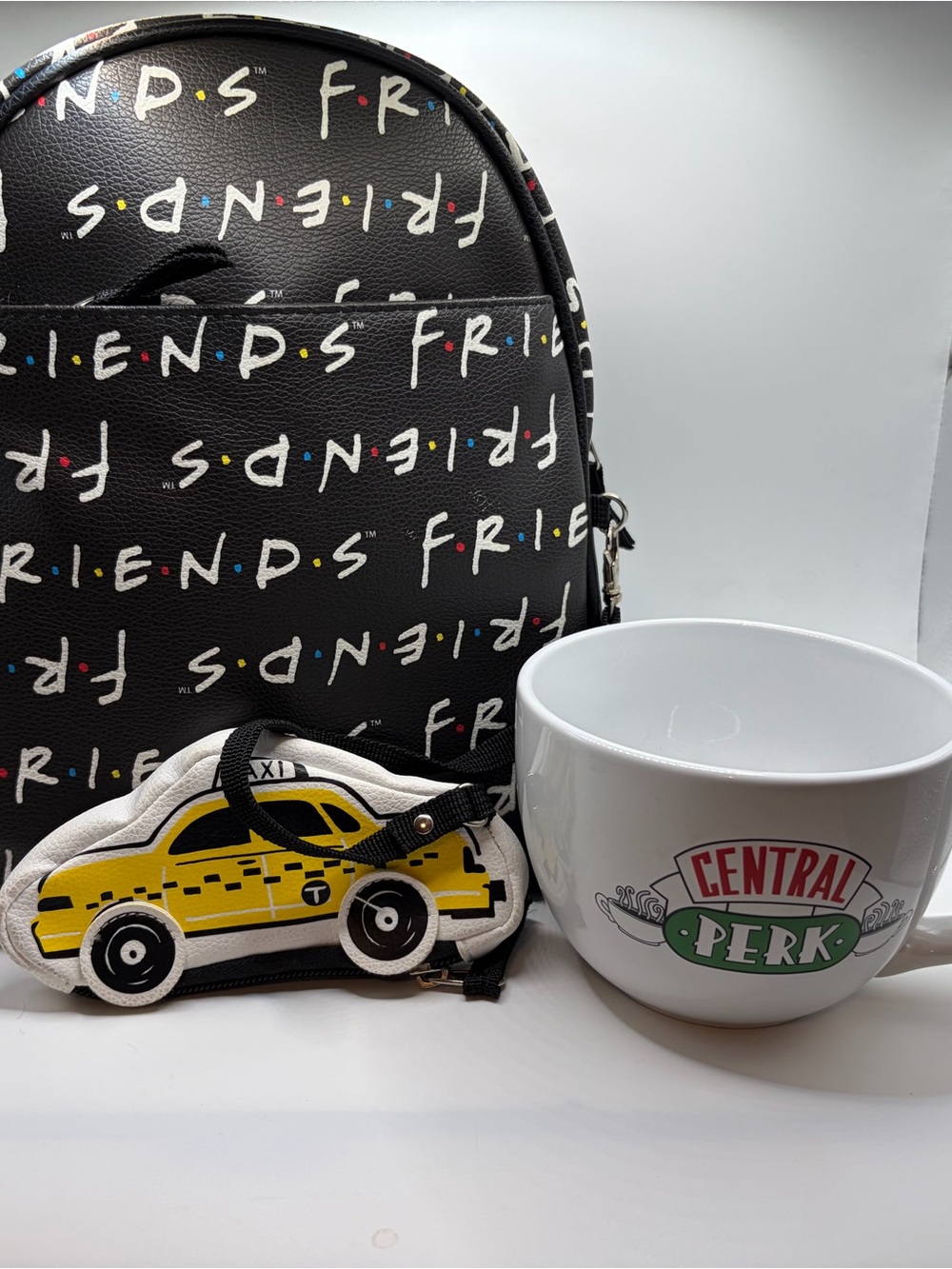 FRIENDS Black Mini Backpack with Yellow Taxi Charm and coffee mug